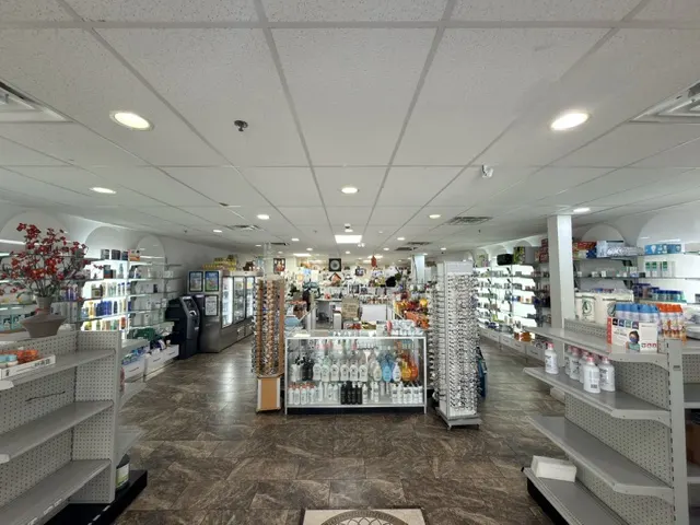Over-the-counter product shelves and eyewear displays inside Patient Care Pharmacy