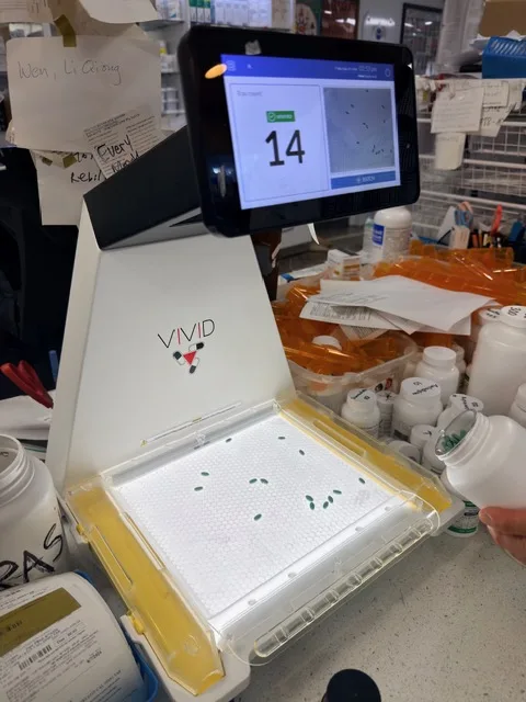 Prescription pill-counting machine displaying a count of fourteen tablets